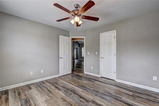 154 Jerry Allen Rdg, Dallas, GA 30132 - unfurnished bedroom featuring wood finished floors, baseboards, and a ceiling fan