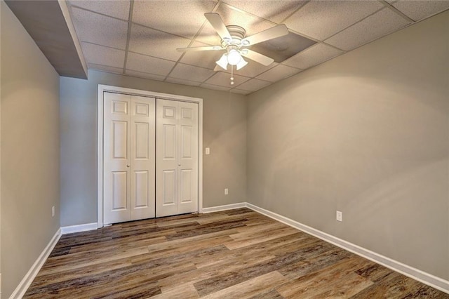 154 Jerry Allen Rdg, Dallas, GA 30132 - unfurnished bedroom featuring wood finished floors, a paneled ceiling, baseboards, a closet, and ceiling fan