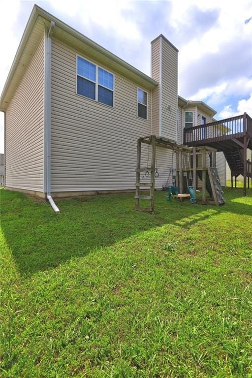 154 Jerry Allen Rdg, Dallas, GA 30132 - rear view of property featuring stairway, a deck, a lawn, and a chimney