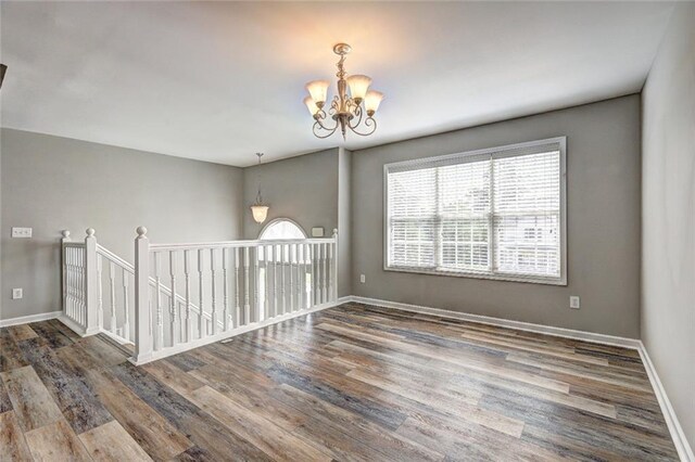 154 Jerry Allen Rdg, Dallas, GA 30132 - empty room with a chandelier, wood finished floors, and baseboards