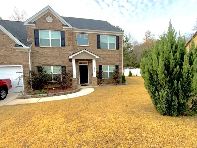 view of front of house with a garage, a front yard, and brick siding