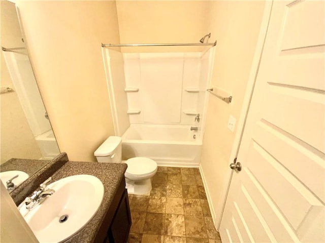 bathroom with shower / bathtub combination, toilet, stone finish flooring, vanity, and baseboards