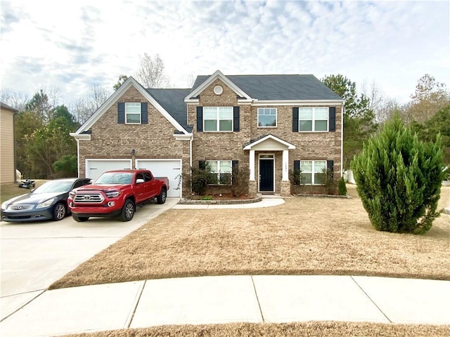 view of front facade featuring a garage, driveway, and brick siding