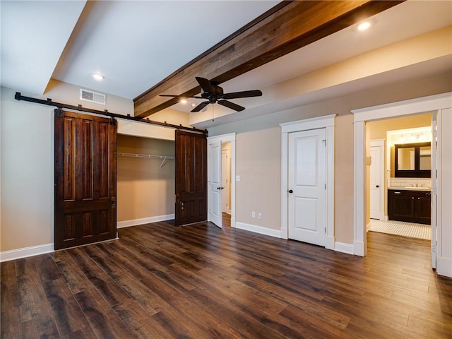 689 Berne St SE, Atlanta, GA 30312 - unfurnished bedroom featuring a barn door, dark wood-style flooring, beamed ceiling, recessed lighting, and ceiling fan
