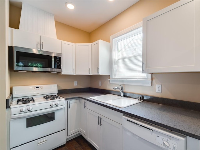 689 Berne St SE, Atlanta, GA 30312 - kitchen with white appliances, dark countertops, white cabinets, recessed lighting, and dark wood finished floors