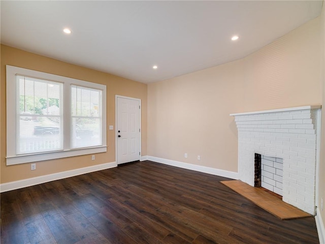 689 Berne St SE, Atlanta, GA 30312 - unfurnished living room featuring dark wood finished floors, a brick fireplace, and recessed lighting