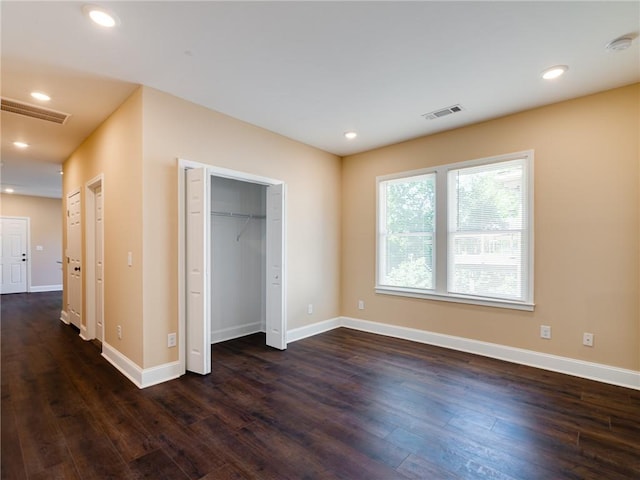 689 Berne St SE, Atlanta, GA 30312 - unfurnished bedroom with dark wood-style floors and recessed lighting