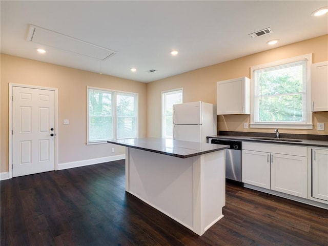 689 Berne St SE, Atlanta, GA 30312 - kitchen featuring freestanding refrigerator, dishwasher, dark countertops, white cabinets, and recessed lighting