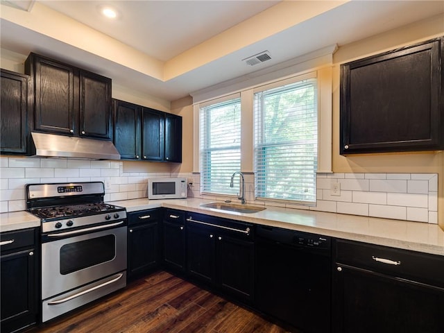 689 Berne St SE, Atlanta, GA 30312 - kitchen with stainless steel gas range oven, under cabinet range hood, dishwasher, white microwave, and light countertops