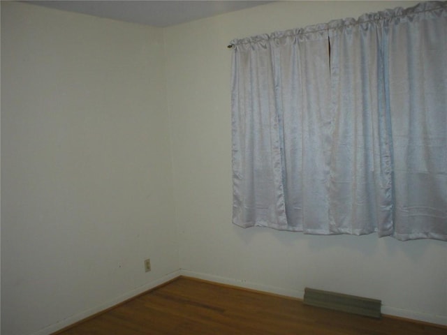 empty room featuring dark wood-type flooring