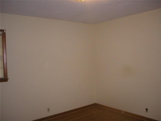 empty room featuring dark wood-type flooring