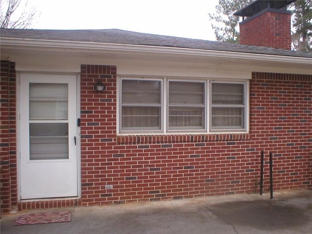 view of exterior entry featuring a patio