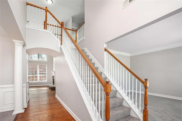 4609 Mctyre Way, Marietta, GA 30064 - staircase featuring crown molding, decorative columns, arched walkways, a towering ceiling, and visible vents