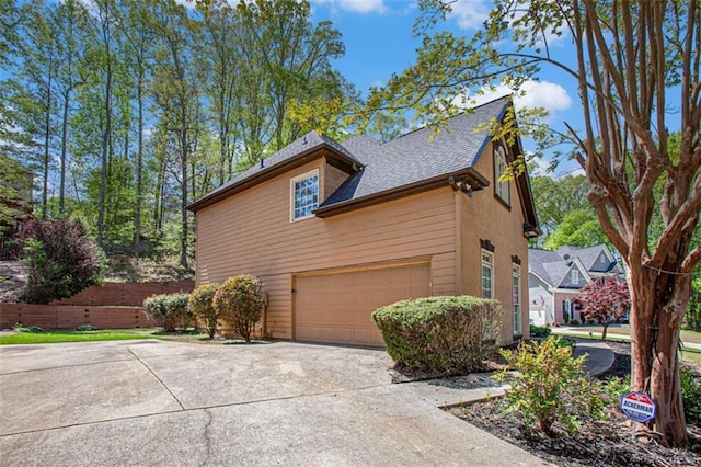 4609 Mctyre Way, Marietta, GA 30064 - view of side of property with roof with shingles, concrete driveway, and a garage