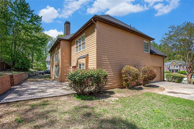 4609 Mctyre Way, Marietta, GA 30064 - view of side of home with concrete driveway, a yard, and a chimney