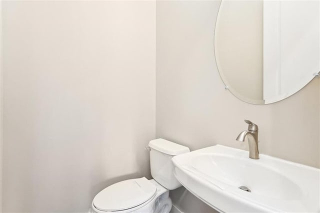 bathroom featuring toilet and a sink