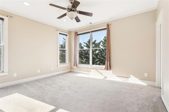 carpeted spare room with a ceiling fan, recessed lighting, baseboards, and ornamental molding