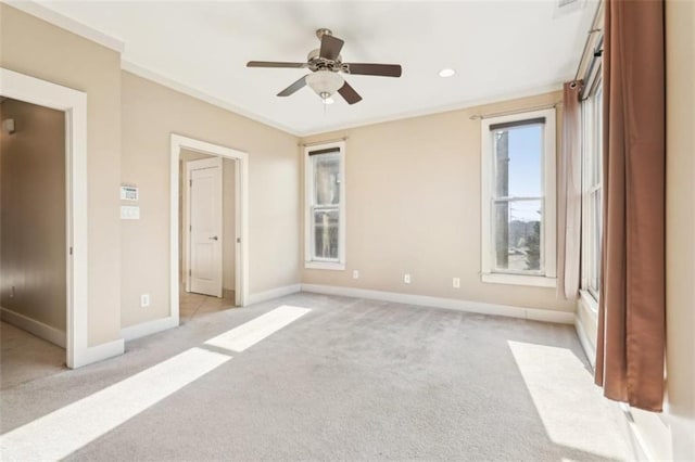 unfurnished bedroom featuring light carpet, crown molding, and baseboards