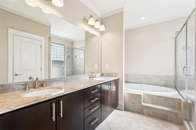 full bath featuring a sink, a garden tub, a stall shower, and double vanity