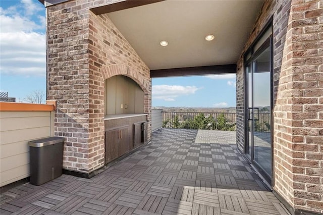 view of patio / terrace with an outdoor brick fireplace