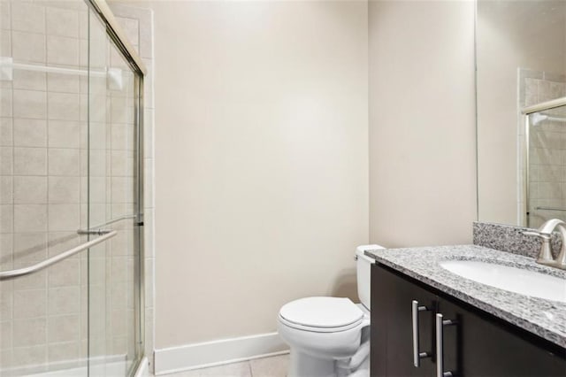 full bathroom with baseboards, toilet, a stall shower, tile patterned floors, and vanity