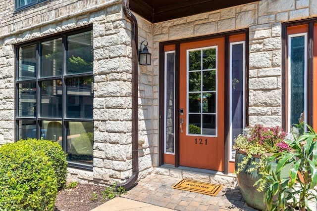 view of exterior entry featuring stone siding