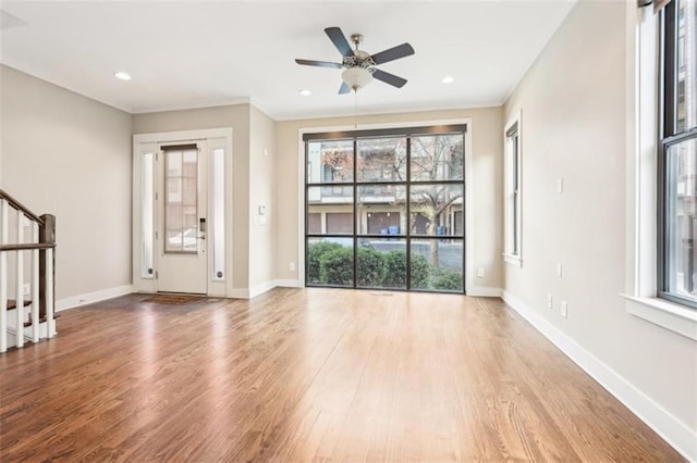 interior space with baseboards, stairway, recessed lighting, wood finished floors, and a ceiling fan