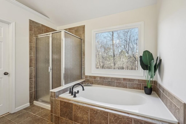 full bathroom featuring a stall shower, a bath, and tile patterned floors