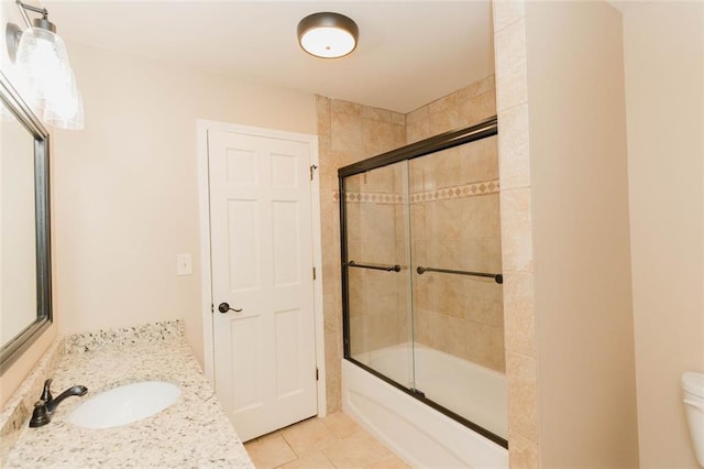 full bathroom featuring vanity, toilet, tile patterned floors, and shower / bath combination with glass door