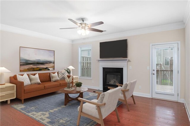 living room with crown molding, a healthy amount of sunlight, and ceiling fan