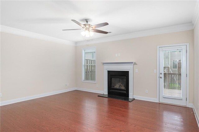 unfurnished living room featuring ceiling fan, dark hardwood / wood-style flooring, and crown molding