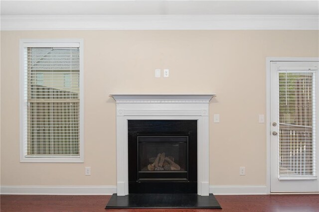 details featuring ornamental molding and hardwood / wood-style flooring