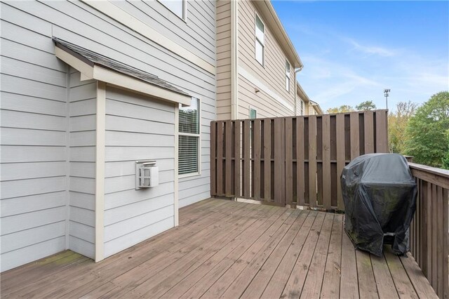 wooden terrace with a grill