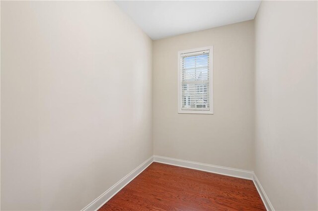 spare room featuring wood-type flooring