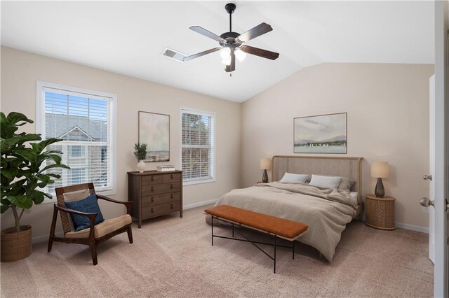 bedroom with ceiling fan, light colored carpet, vaulted ceiling, and multiple windows