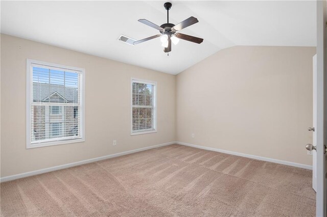 carpeted empty room with ceiling fan and vaulted ceiling