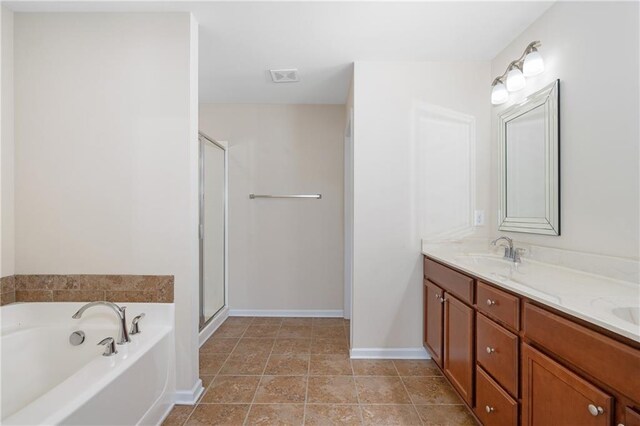 bathroom with independent shower and bath, tile patterned flooring, and vanity