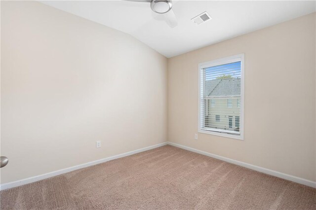 unfurnished room with ceiling fan, vaulted ceiling, and carpet flooring