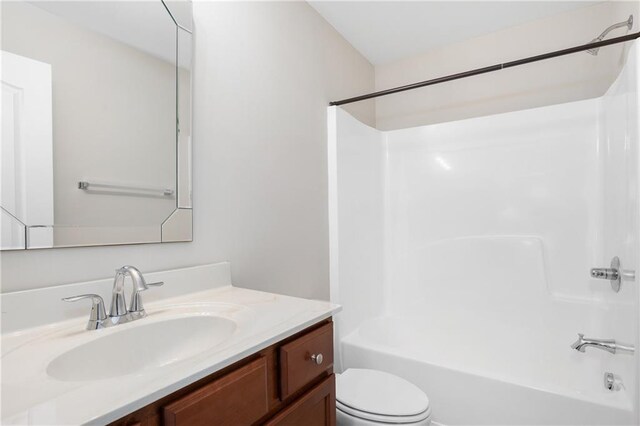 full bathroom with toilet, vanity, and bathtub / shower combination