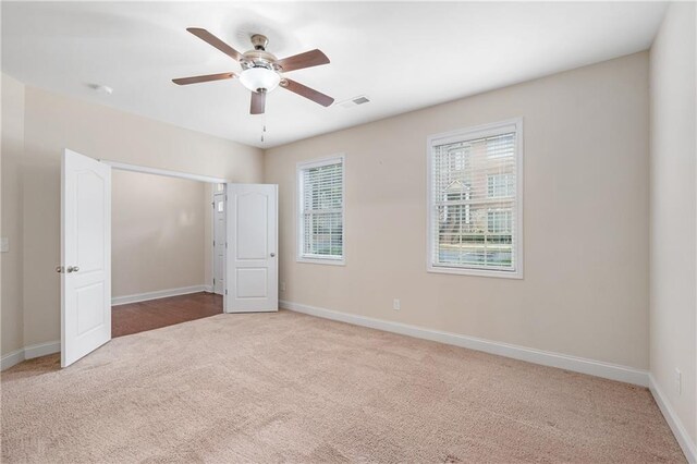 unfurnished bedroom featuring ceiling fan and carpet floors