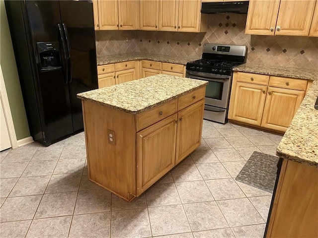 kitchen with under cabinet range hood, light tile patterned flooring, black refrigerator with ice dispenser, and stainless steel gas range oven