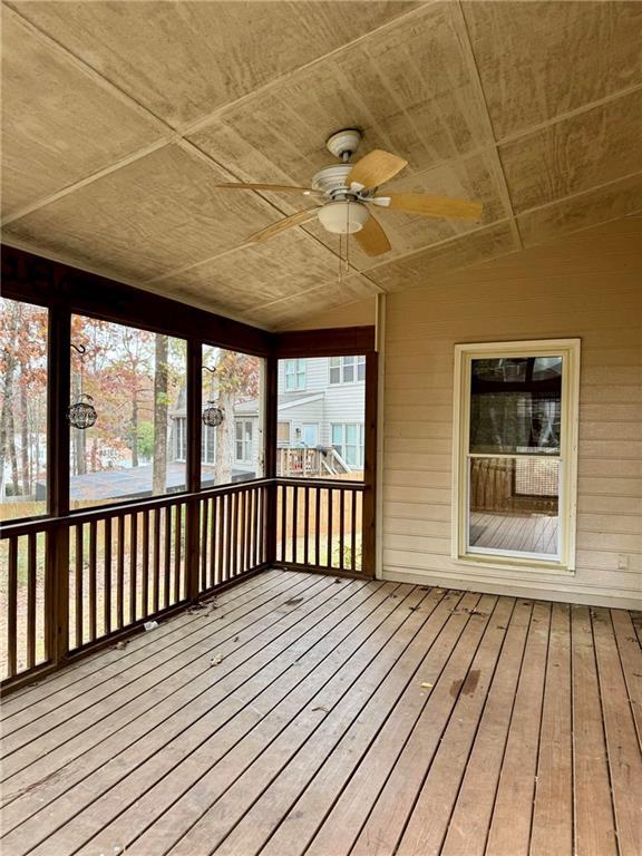 unfurnished sunroom featuring wood ceiling, ceiling fan, and lofted ceiling