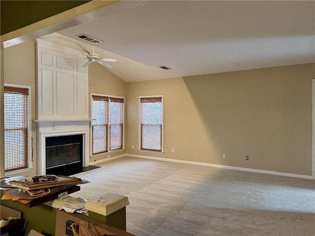 unfurnished living room featuring baseboards, visible vents, light colored carpet, lofted ceiling, and a fireplace