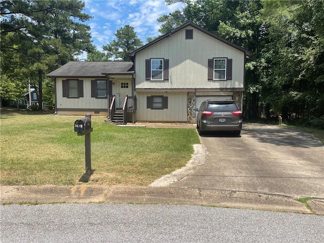 tri-level home with a front lawn and a garage