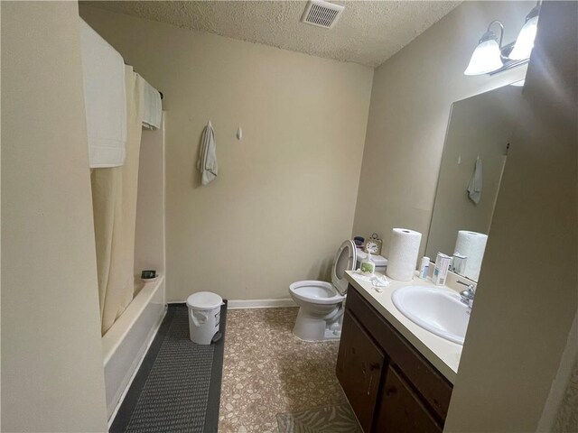 full bathroom featuring tile flooring, oversized vanity, a textured ceiling, shower / bathtub combination with curtain, and toilet