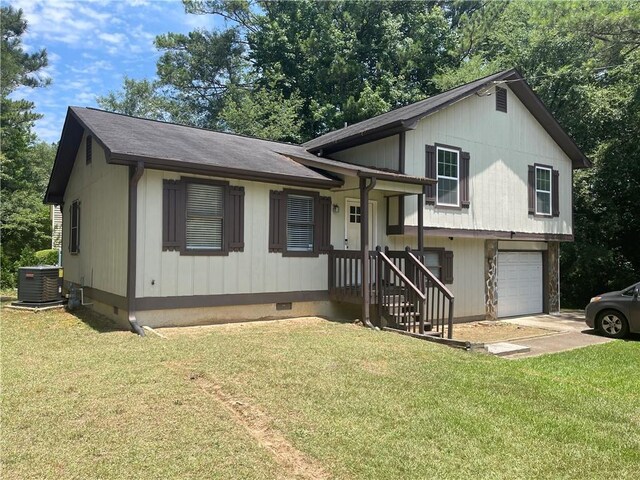 tri-level home featuring a garage, central AC, and a front yard