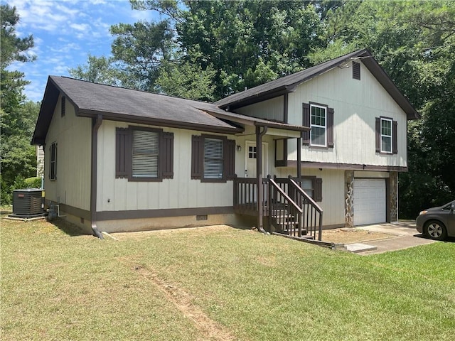 tri-level home with central AC, a front yard, and a garage