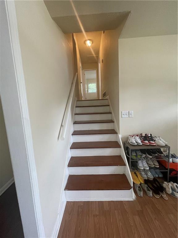 stairway featuring hardwood / wood-style flooring