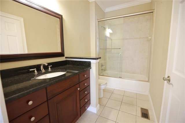 3541 Roswell Rd NE Unit 20, Atlanta, GA 30305 - bathroom featuring crown molding, toilet, vanity, tile patterned floors, and shower / bath combination with glass door