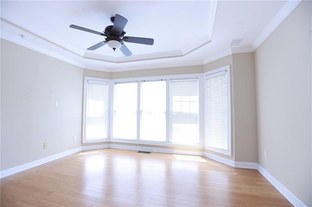 3541 Roswell Rd NE Unit 20, Atlanta, GA 30305 - empty room with ornamental molding, a tray ceiling, plenty of natural light, light wood finished floors, and baseboards